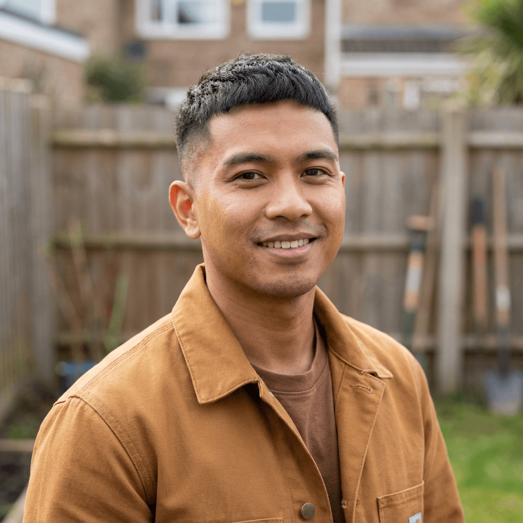 Image of male cafe owner in his early 40s, Black, professional and approachable demeanor appropriate for small business service
